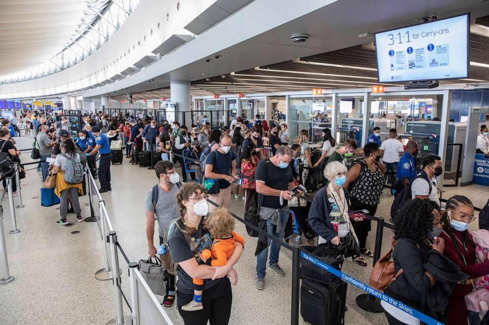PHOTO: Passengers endure a long queue for security screenings at John F. Kennedy International Airport in New York, Aug. 19, 2021.