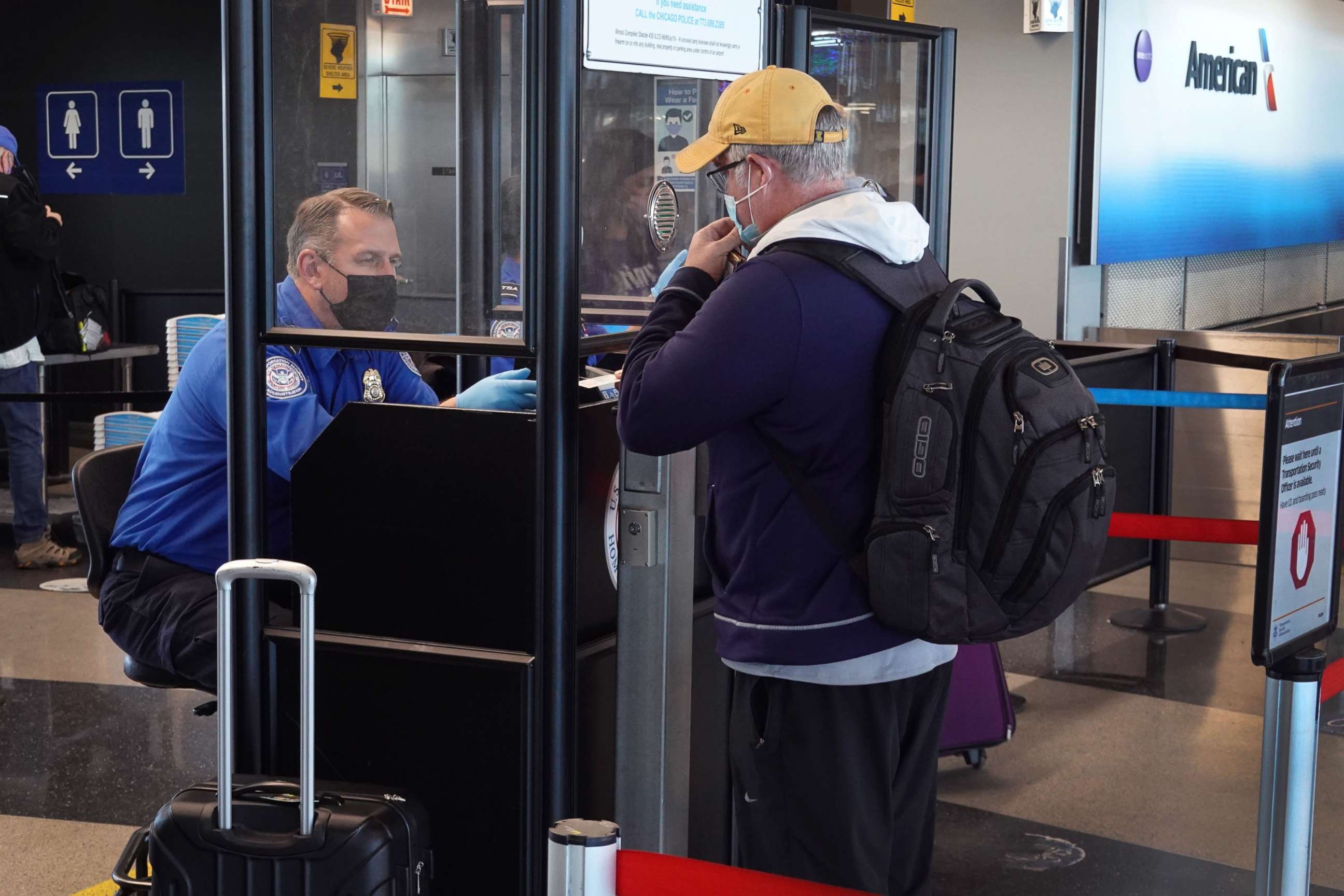 PHOTO: Transportation Security Administration (TSA) workers screen passengers at O'Hare International Airport on Nov. 08, 2021, in Chicago.