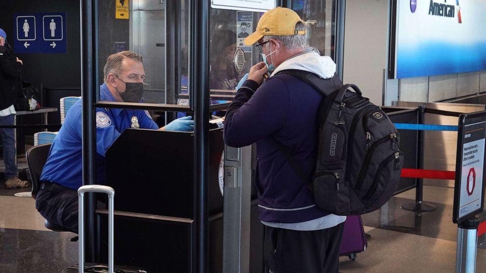 PHOTO: Transportation Security Administration (TSA) workers screen passengers at O'Hare International Airport on Nov. 08, 2021, in Chicago.