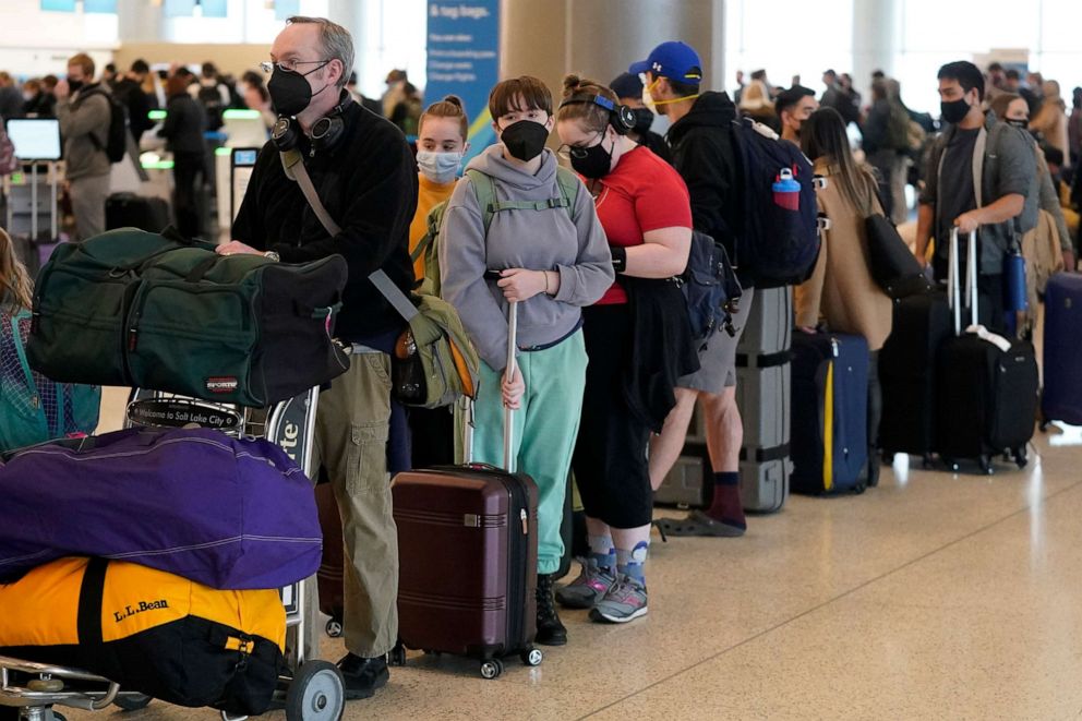 PHOTO: Travelers wait in the ticketing line at Salt Lake City International Airport, Dec. 27, 2021, in Salt Lake City.