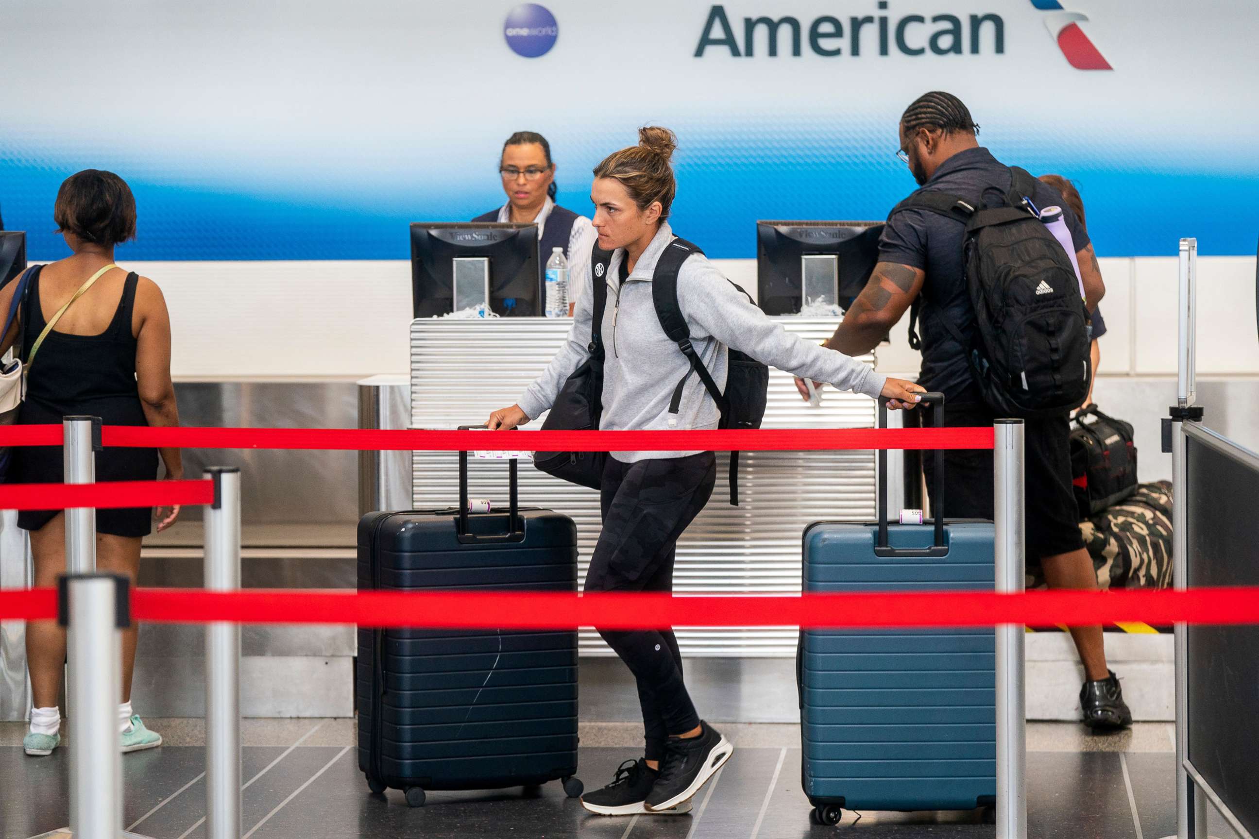 PHOTO: In this July 1, 2022, file photo, passengers check in at the American Airlines ticketing counter at Ronald Reagan Washington National Airport in Arlington, Va.