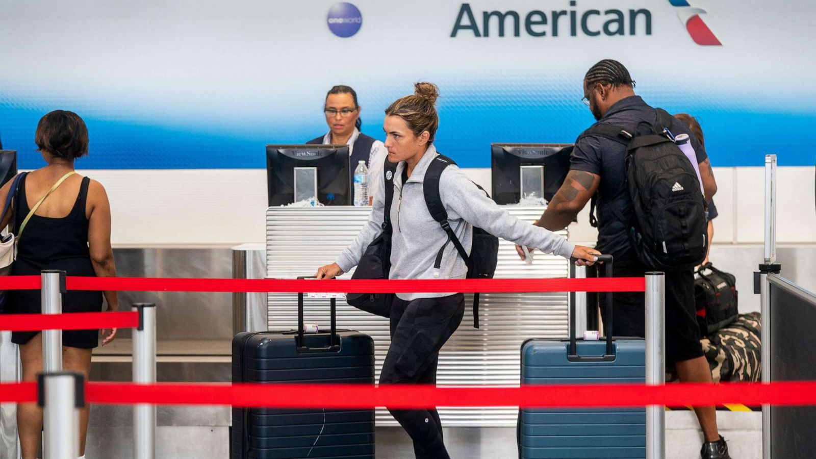 PHOTO: In this July 1, 2022, file photo, passengers check in at the American Airlines ticketing counter at Ronald Reagan Washington National Airport in Arlington, Va.