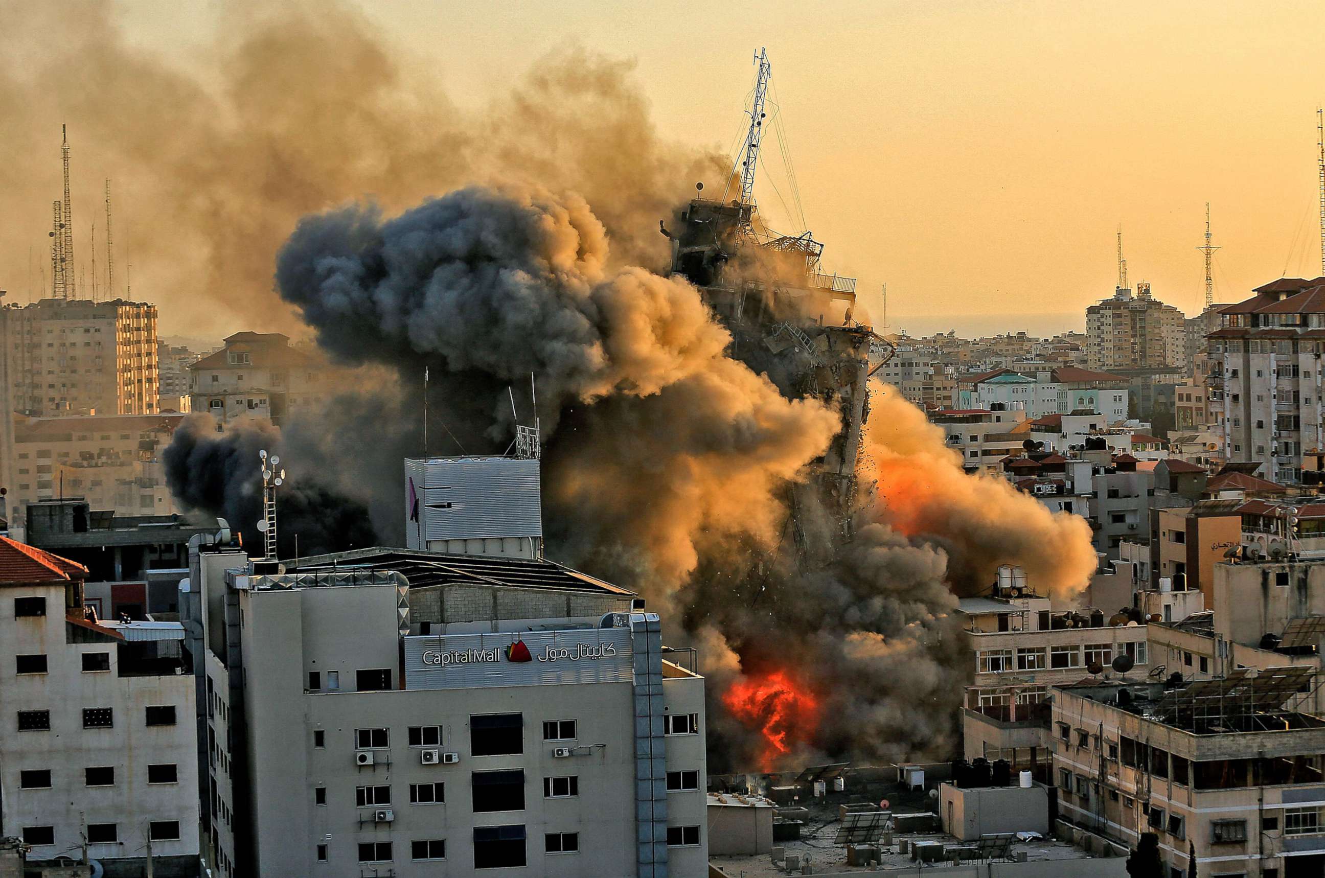 PHOTO: Heavy smoke and fire rise from Al-Sharouk tower as it collapses after being hit by an Israeli air strike, in Gaza City, May 12, 2021.