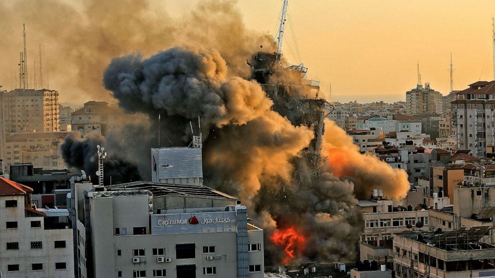 PHOTO: Heavy smoke and fire rise from Al-Sharouk tower as it collapses after being hit by an Israeli air strike, in Gaza City, May 12, 2021.