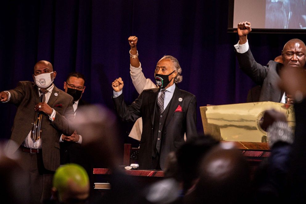 The Rev. Al Sharpton, center, raises his fist during the funeral of Daunte Wright at the Shiloh Temple International Ministries in Minneapolis on April 22, 2021.