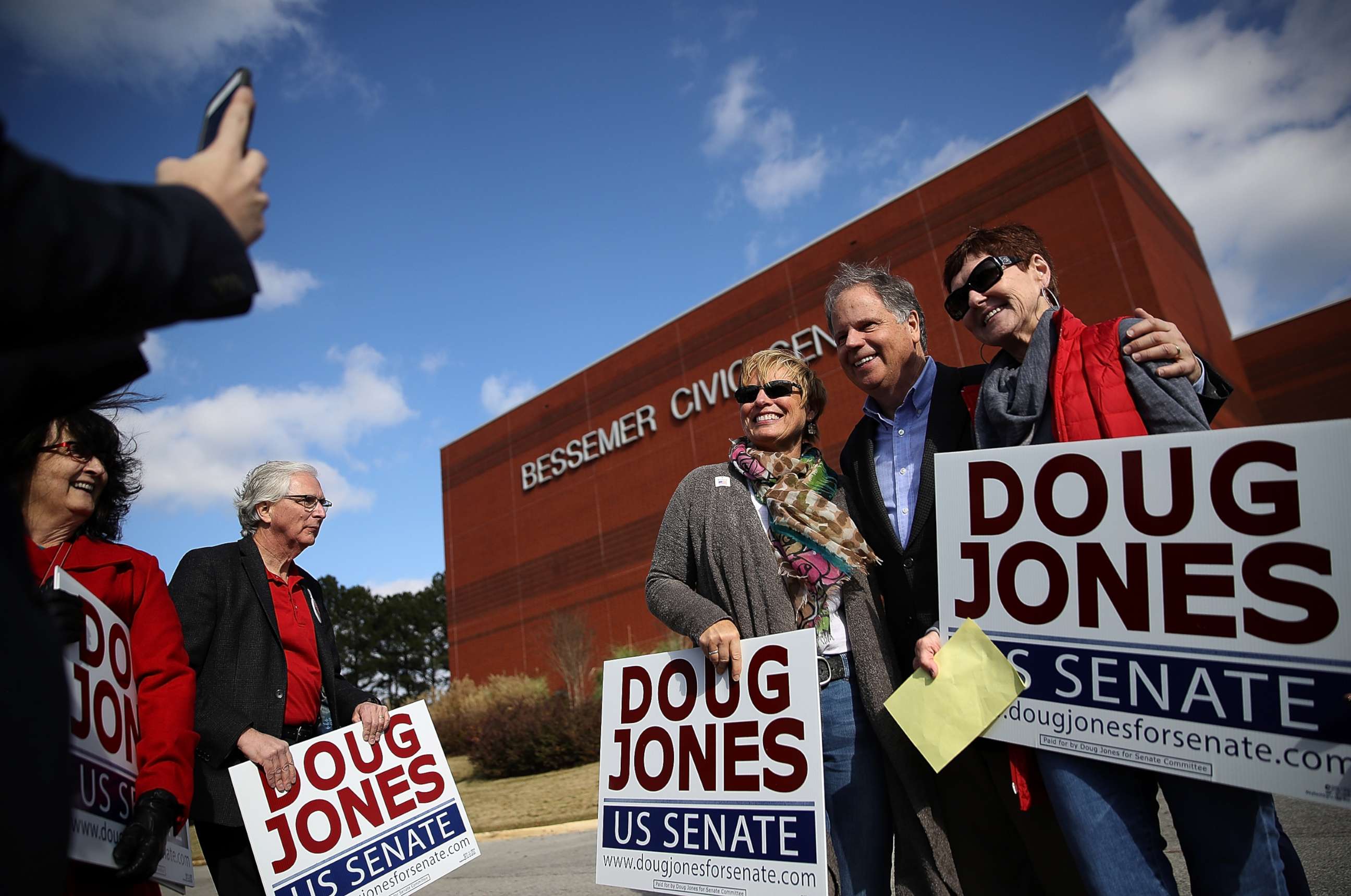 PHOTO: Democratic senatorial candidate Doug Jones takes a picture with voters outside of a polling station at the Bessemer Civic Center on Dec. 12, 2017 in Bessemer, Ala.