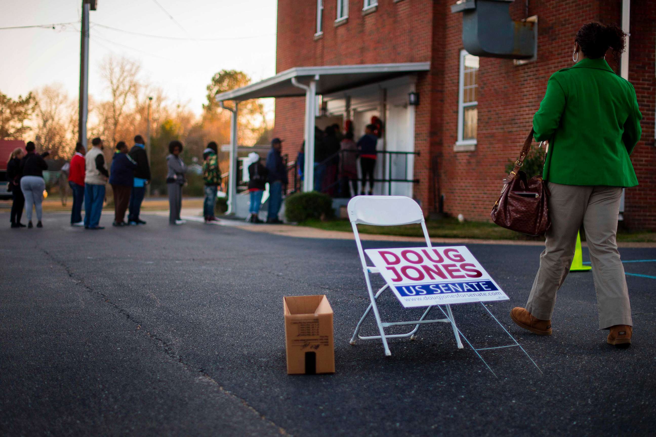 PHOTO: A woman walks over to get in line to vote at Beulah Baptist Church polling station in Montgomery, Ala. on Dec. 12, 2017.