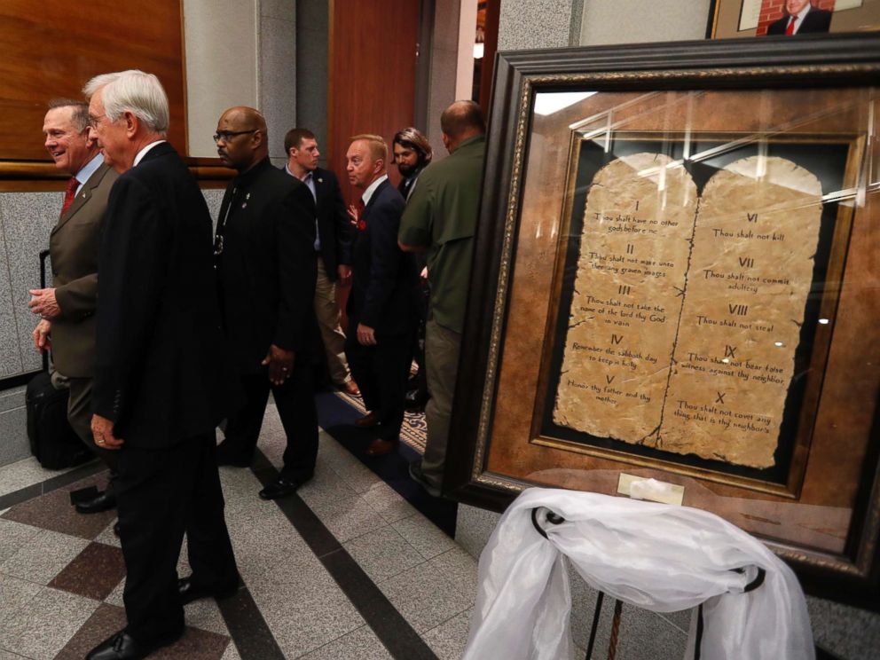 PHOTO: Republican Senate candidate Roy Moore passes by a display of the Ten Commandments as he arrives at his election night party in Montgomery, Ala., Dec. 12, 2017.