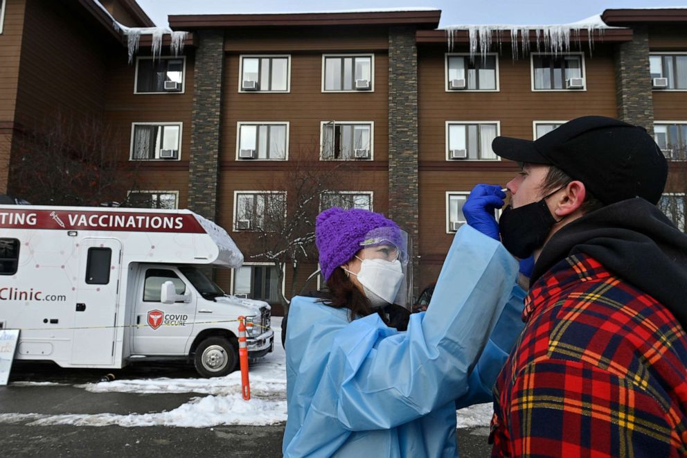 PHOTO: Dr. Jodie Guest tests Iditarod musher Matthew Failor for COVID-19 at a mobile clinic in front of Lakefront Hotel in Anchorage, Alaska, March 3, 2021.