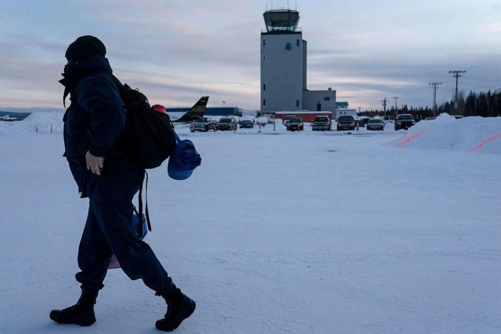 PHOTO: United States Public Health Service nurse, Faith Walsh carries a cooler containing a single vial of Moderna coronavirus disease (COVID-19) vaccine to her flight out of Fairbanks, Alaska, March 31, 2021.