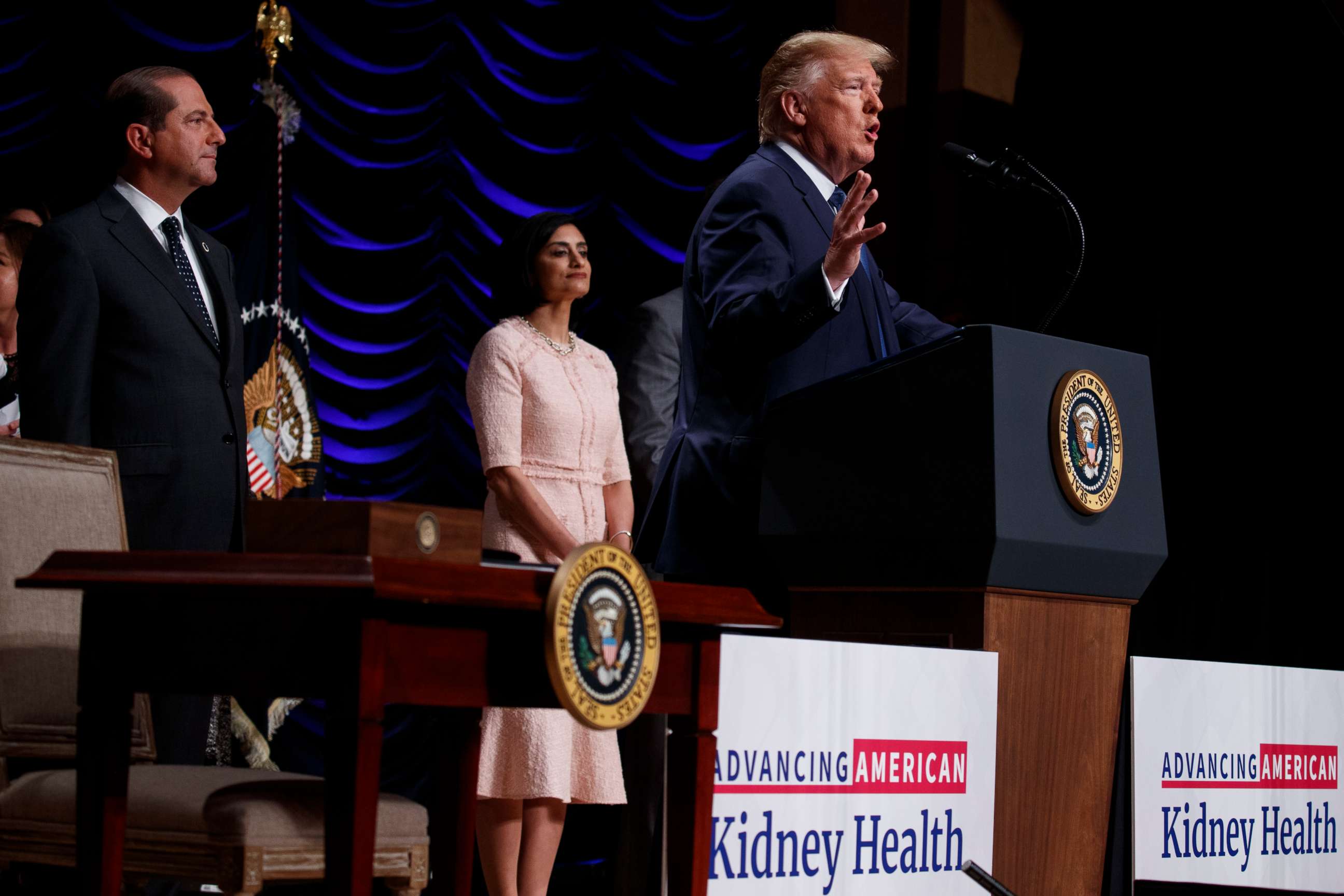 PHOTO: Secretary of Health and Human Services Alex Azar and administrator of the Centers for Medicare and Medicaid Services Seema Verma look on as President Donald Trump speaks in Washington, July 10, 2019.