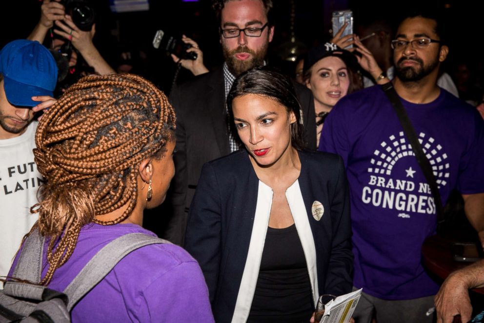   PHOTO: Alexandria Ocasio-Cortez celebrates with her supporters at a Victory Day in the Bronx after overthrowing outgoing Democratic Representative Joseph Crowly on June 26, 2018, in New York. 