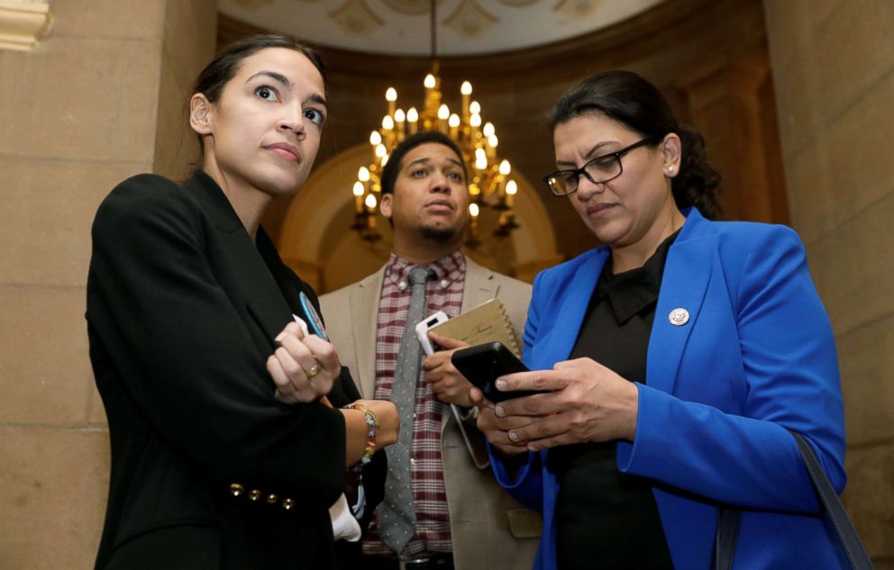PHOTO: Reps. Alexandria Ocasio-Cortez, left, and Rashida Tlaib talk as they accompany other freshmen House Democrats to Senate Majority Leader Mitch McConnell's office on Capitol Hill in Washington, DC, Jan. 16, 2019.