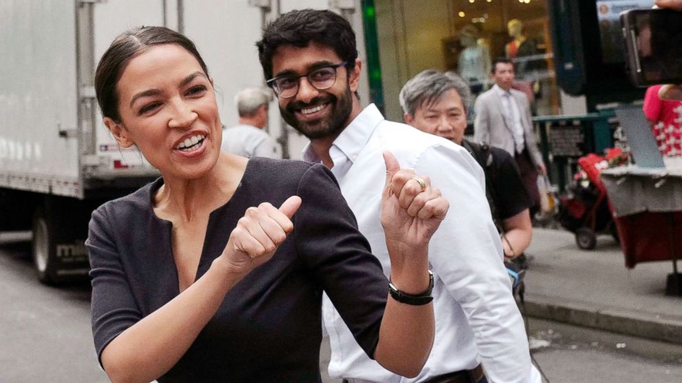 Alexandria Ocasio-Cortez, the winner of a Democratic Congressional primary in New York, reacts to a passerby, June 27, 2018, in New York. Ocasio-Cortez, 28, upset U.S. Rep. Joe Crowley in Tuesday's election.