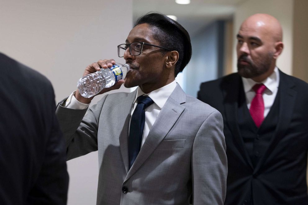 PHOTO: Stop the Steal organizer Ali Alexander takes a sip of water as he returns to a conference room for a deposition meeting on Capitol Hill with the House select committee investigating the Jan. 6 attack on Dec. 9, 2021, in Washington, D.C.