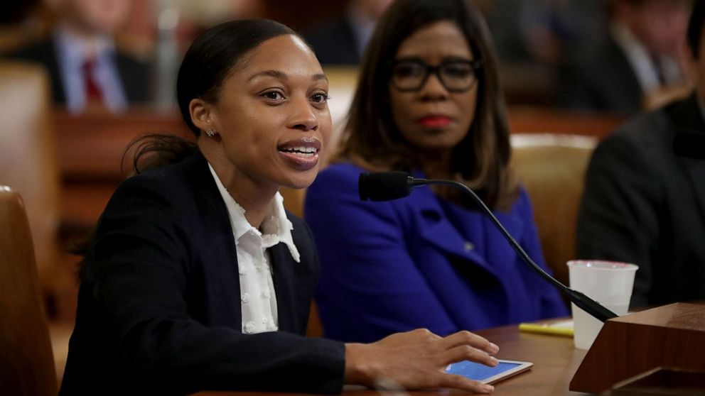 U.S. track and field Olympian Allyson Felix testifies before the House Ways and Means Committee about how she had a severe case of preeclampsia that led to an emergency C-section childbirth at 32 weeks during a hearing about maternal mortality on Capitol Hill, May 16, 2019 in Washington, D.C. American Medical Association President-elect Patrice Harris, listens at right.
