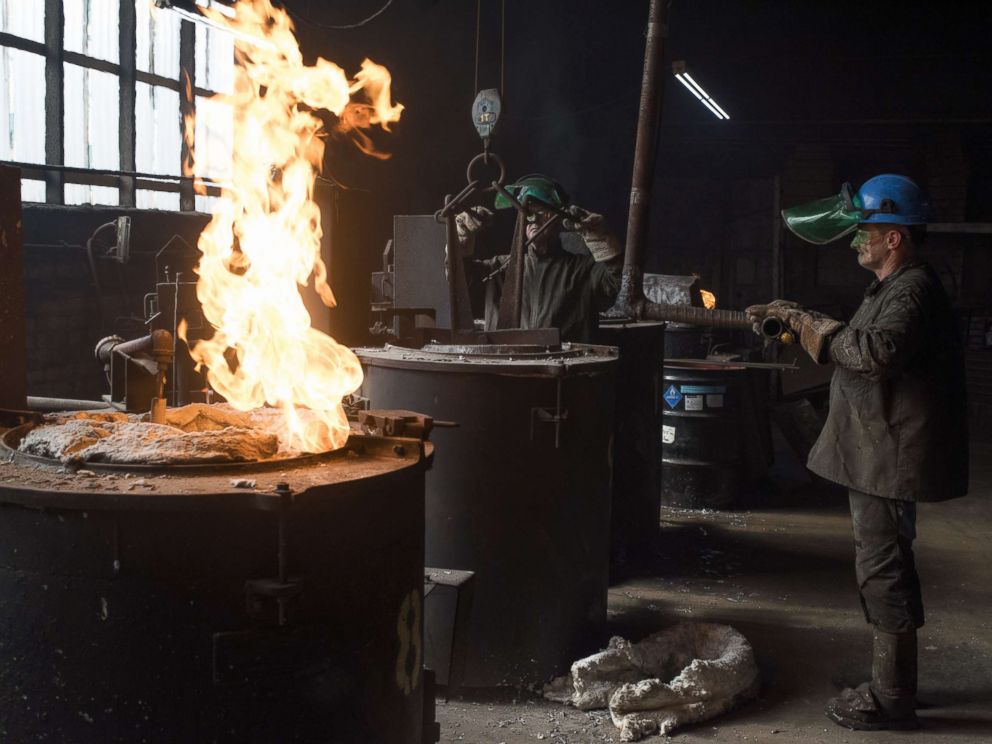 PHOTO: Employees prepare to load a crucible containing molten aluminum onto a hoist at the Lite Metals Co. foundry in Ravenna, Ohio, Sept. 20, 2017.