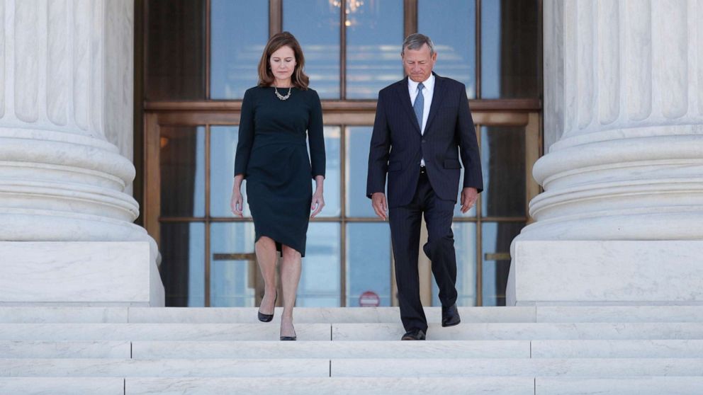 PHOTO: Supreme Court Justice Amy Coney Barrett walks with Chief Justice John Roberts following an investiture ceremony at the U.S. Supreme Court on Capitol Hill in Washington, Oct. 1, 2021.