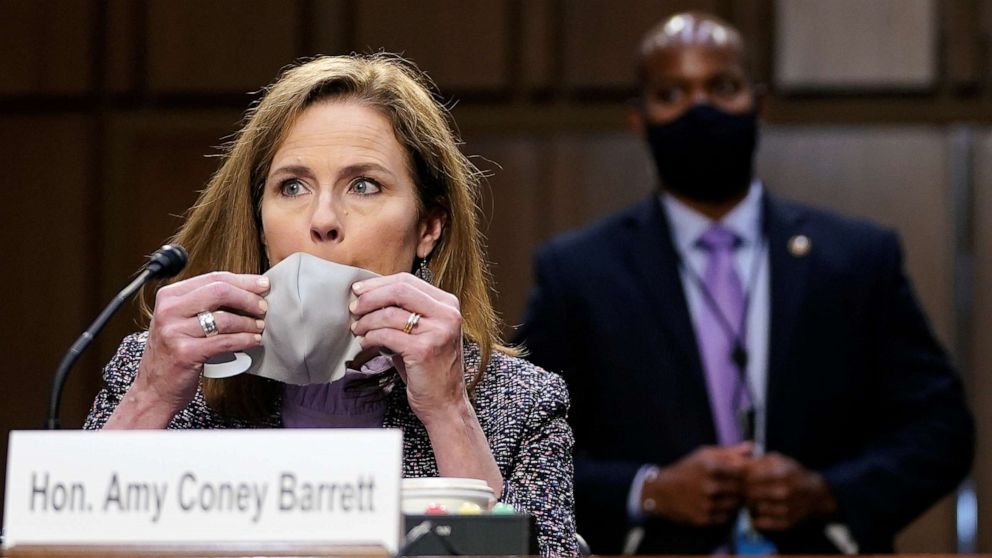 PHOTO: Judge Amy Coney Barrett puts her protective mask on before a break during the third day of her Senate confirmation hearing to the Supreme Court on Capitol Hill in Washington, Oct. 14, 2020.