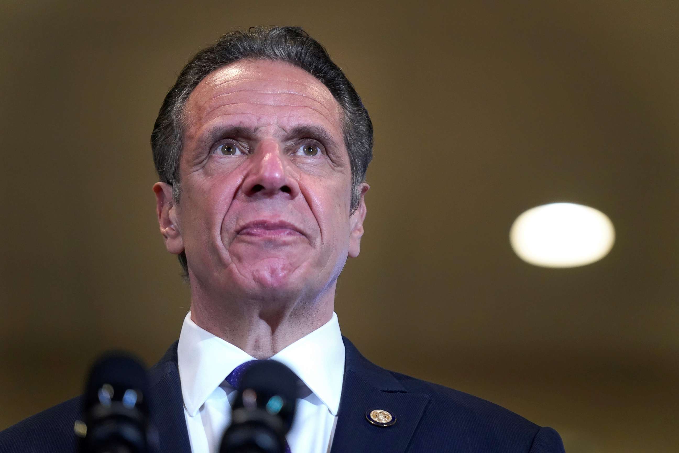 PHOTO: New York Governor Andrew Cuomo listens to speakers in Mt. Vernon, N.Y., March 22, 2021.