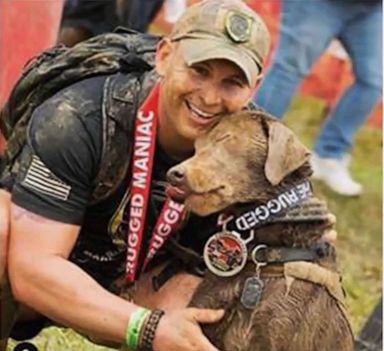 PHOTO: Officer Andrew Einstein is pictured with his service dog.