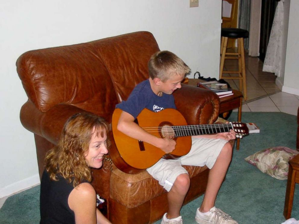PHOTO: Andrew around age 11 playing guitar with his mom, Gayle, beside him. They started taking lessons together, and Gayle says Andrew still enjoys playing when he's well.