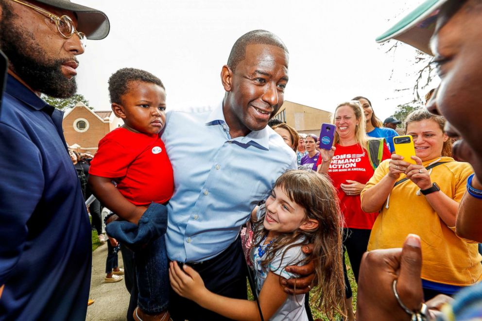 PHOTO: Democratic gubernatorial candidate Andrew Gillum holds his son Davis as he greets well-wishers outside his polling place after voting during midterm elections in Tallahassee, Fla., Nov. 6, 2018.