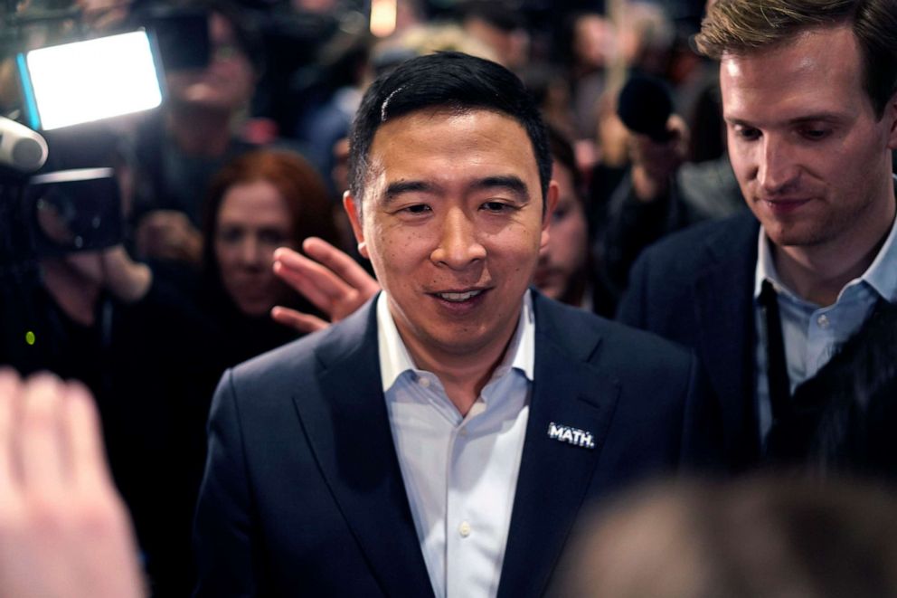 PHOTO: Entrepreneur Andrew Yang walks through a crowd of media after the Democratic presidential candidates debate at Loyola Marymount University in Los Angeles, Dec. 19, 2019.