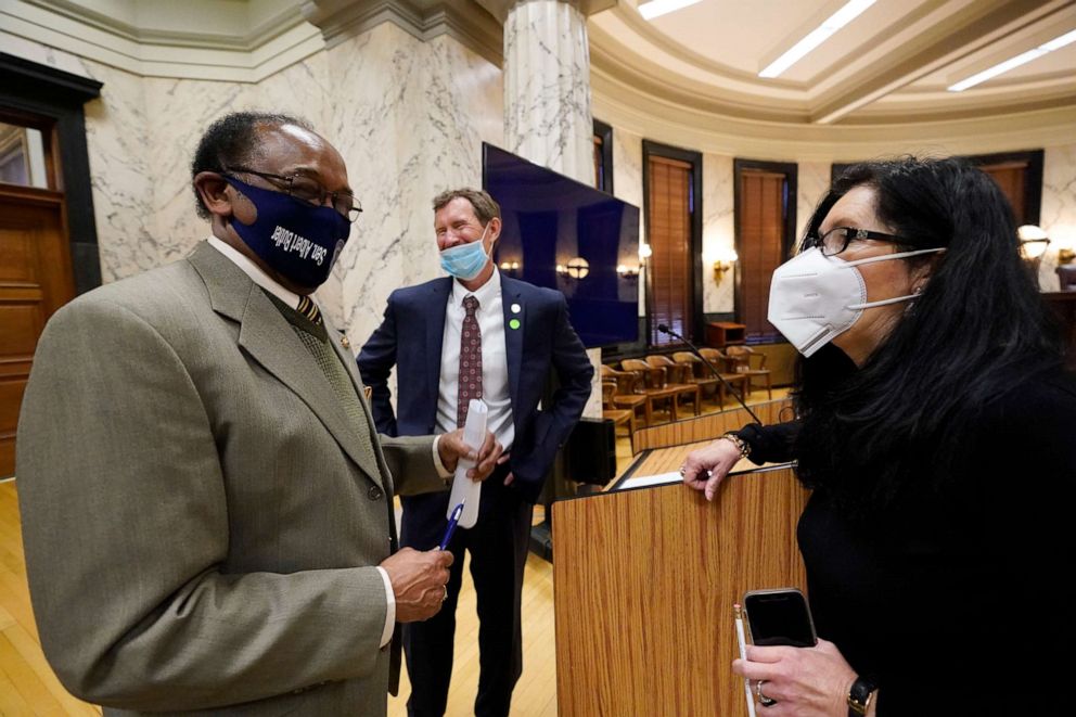 PHOTO: Sens. Albert Butler, left, and Angela Hill, right, following a meeting of the Senate Accountability, Efficiency, Transparency Committee at the Capitol in Jackson, Miss., March 2, 2021.