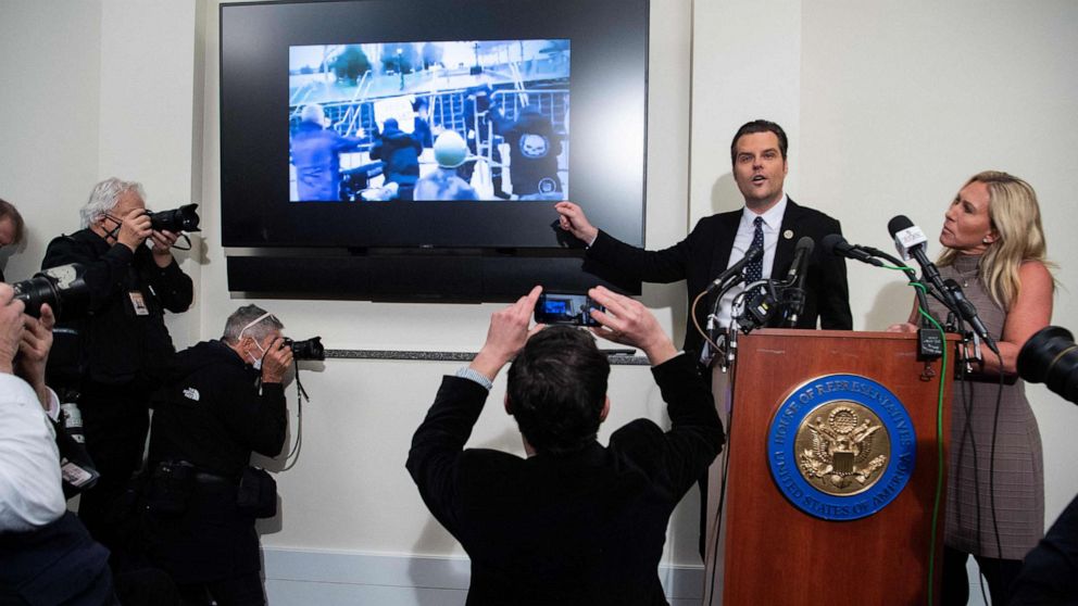 PHOTO: Representatives Marjorie Taylor Greene and Representative Matt Gaetz show video from the January 6, 2021 attack on the US Capitol as they speak about what they say happened that day, during a press conference in Washington, DC, Jan. 6, 2022.