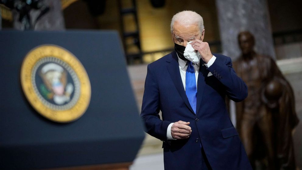 PHOTO: President Joe Biden wipes his eyes as Vice President Kamala Harris delivers remarks on the one year anniversary of the January 6 attack on the U.S. Capitol, during a ceremony in Statuary Hall at the U.S. Capitol in Washington, Jan. 6, 2022.