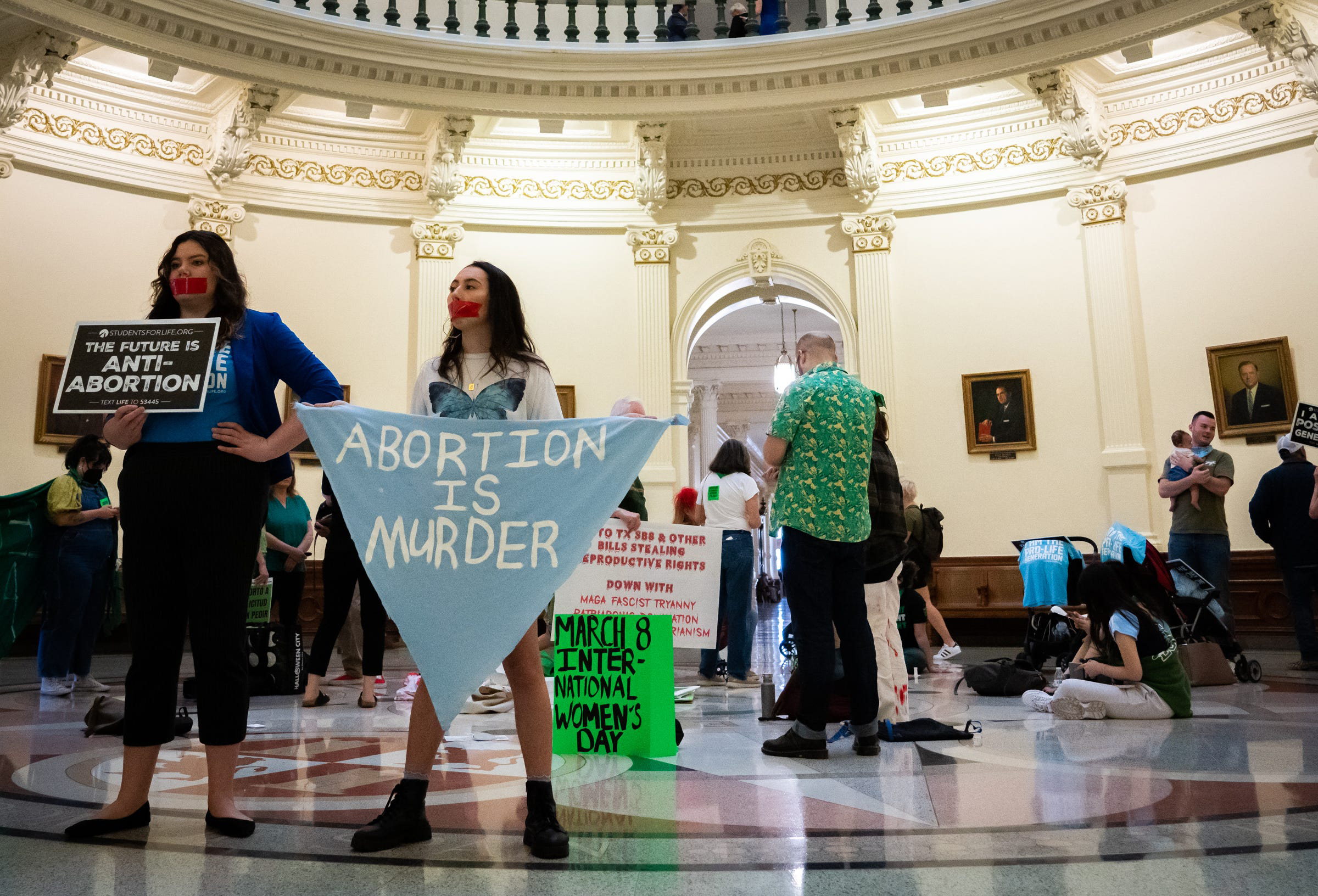 PHOTO: Anti-abortion protesters stand on the Texas State Capitol Rotunda to protest an International Women's Day Sit-In for Abortion Rights, on March 8, 2023, in Austin, Texas.