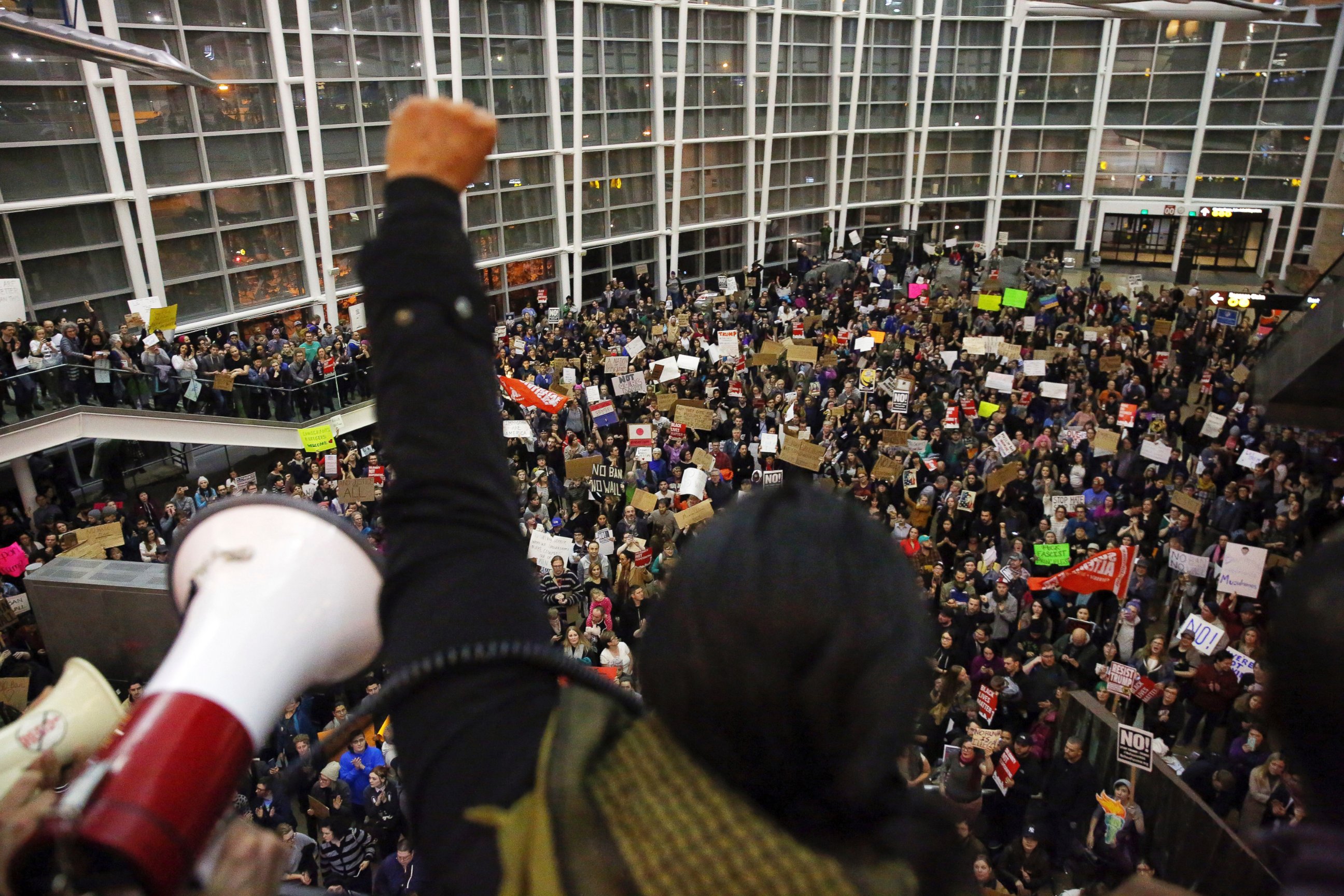 PHOTO: Seattle city councilwoman Kshama Sawant raises a fist over the crowd, as more than 1,000 people gather at Seattle-Tacoma International Airport, to protest President Donald Trump's order that restricts immigration to the U.S., Jan. 28, 2017. 