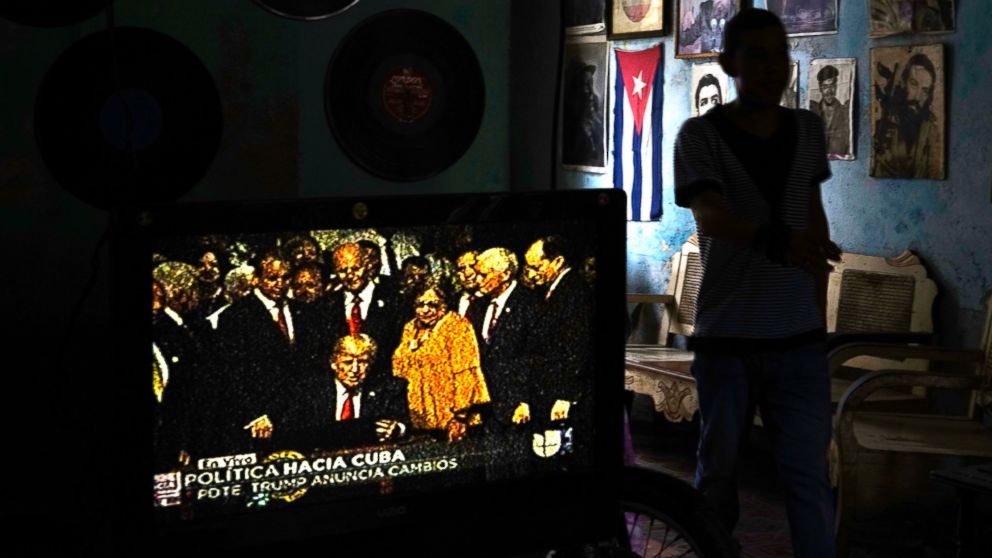 A television set shows President Donald Trump signing the new Cuba policy in a living room festooned with images of Cuban leaders at a house in Havana, Cuba, June 16, 2017.