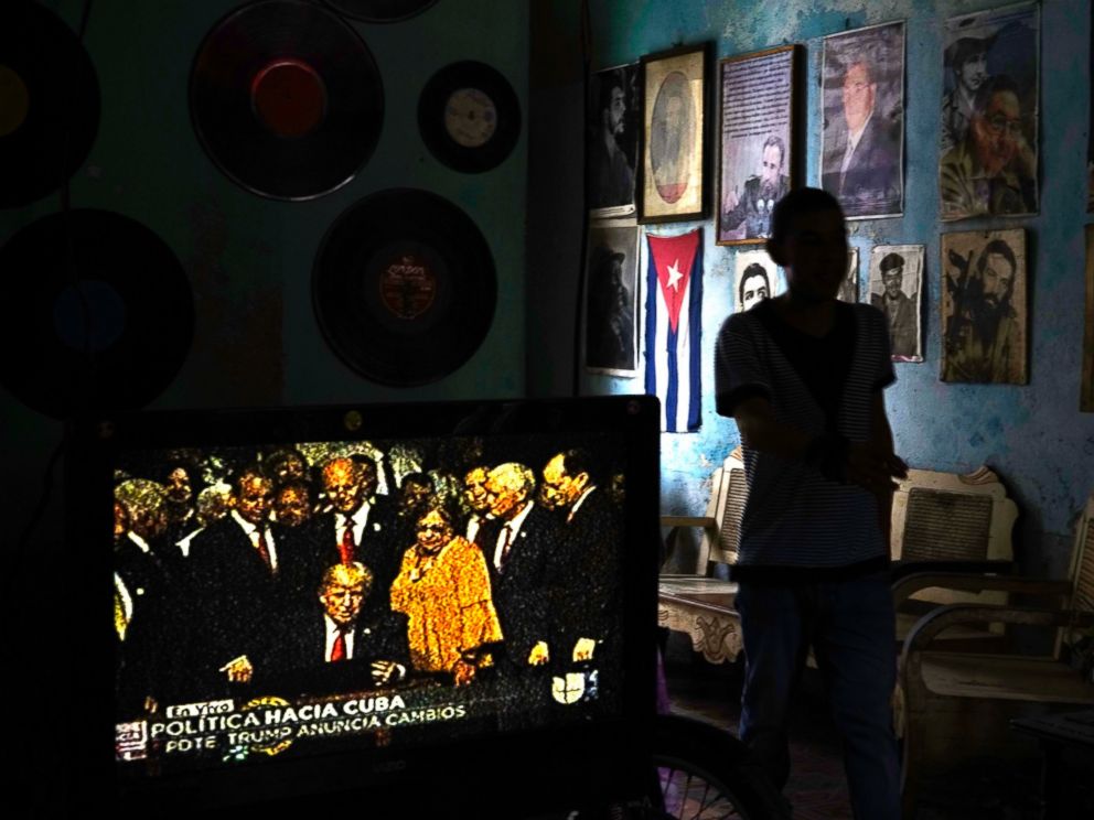 PHOTO: A television set shows President Donald Trump signing the new Cuba policy in a living room festooned with images of Cuban leaders at a house in Havana, Cuba, June 16, 2017.