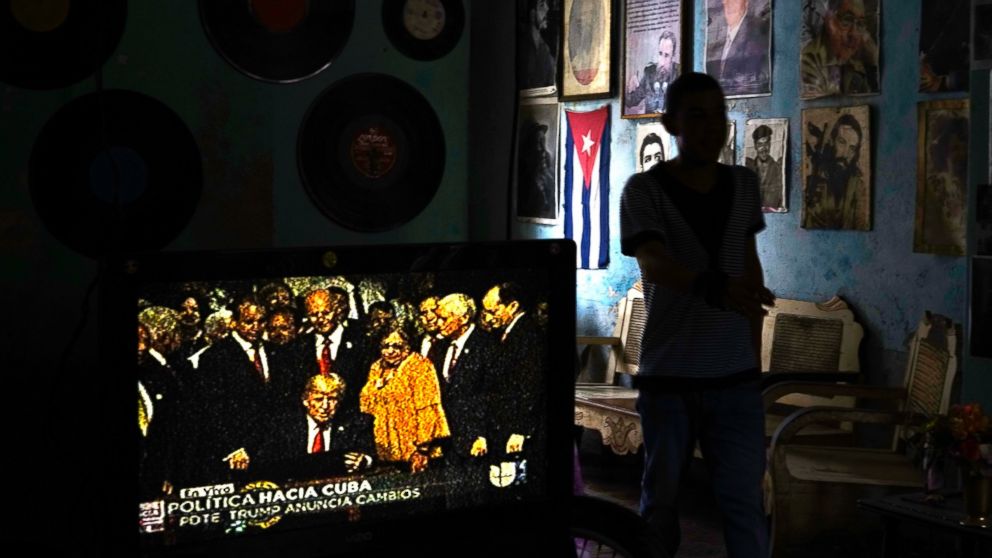 PHOTO: A television set shows President Donald Trump signing the new Cuba policy in a living room festooned with images of Cuban leaders at a house in Havana, Cuba, June 16, 2017. 