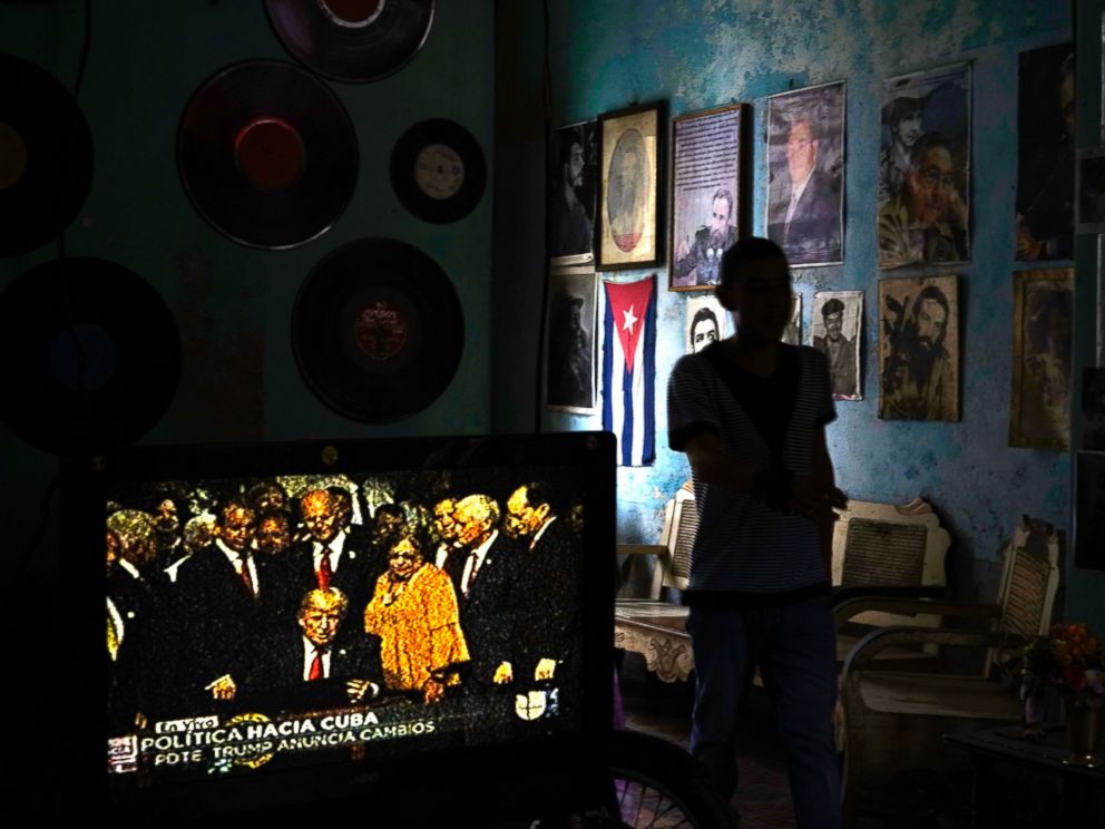 PHOTO: A television set shows President Donald Trump signing the new Cuba policy in a living room festooned with images of Cuban leaders at a house in Havana, Cuba, June 16, 2017.
