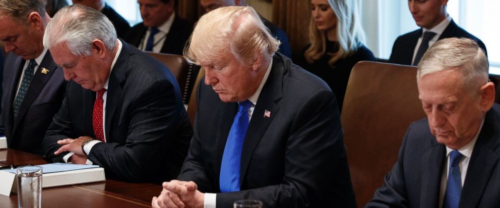 President Donald Trump prays during a cabinet meeting at the White House, Wednesday, Dec. 20, 2017, in Washington. From left, Secretary of Interior Ryan Zinke, Secretary of State Rex Tillerson, Trump, and Secretary of Defense Jim Mattis.