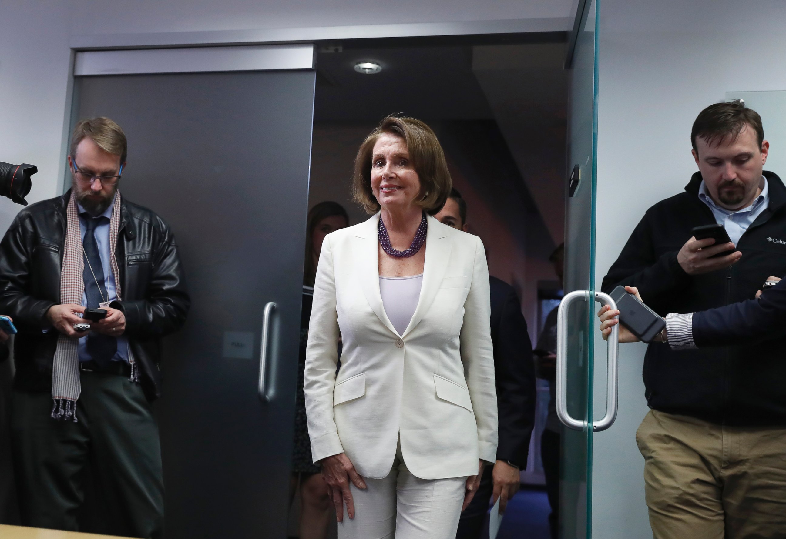 PHOTO: House Minority Leader Nancy Pelosi, clad in a white pantsuit, arrives for an election day news conference at the Democratic Congressional Campaign Committee Headquarters in Washington, D.C., Nov. 8, 2016.