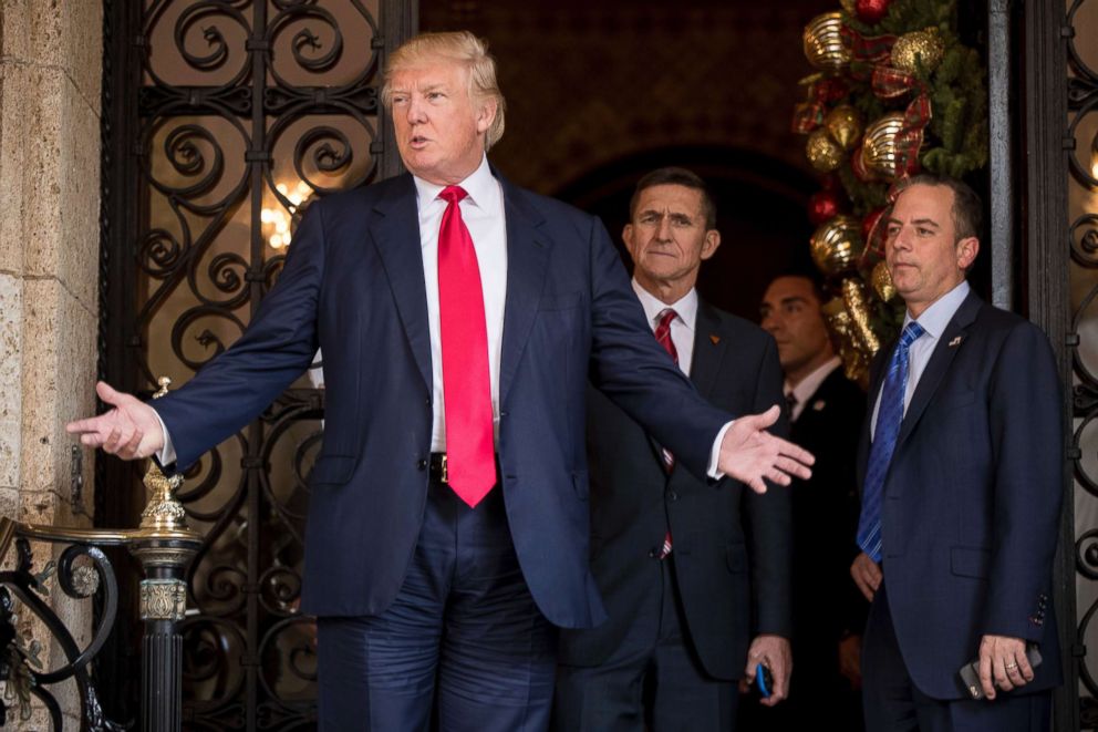 PHOTO: President-elect Donald Trump, left, accompanied by Trump Chief of Staff Reince Priebus, right, and Retired Gen. Michael Flynn, a senior adviser to Trump, center, speaks to members of the media at Mar-a-Lago, in Palm Beach, Florida, Dec. 21, 2016.