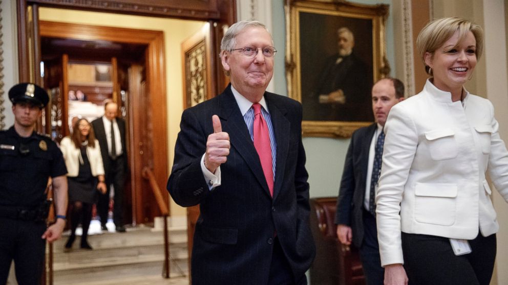Senate Majority Leader Mitch McConnell gives a thumbs-up as he leaves the Senate chamber on Capitol Hill in Washington, D.C., April 6, 2017, after he led the GOP majority to change Senate rules and lower the vote threshold for Supreme Court nominees from 60 votes to a simple majority in order to advance Neil Gorsuch to a confirmation vote.
