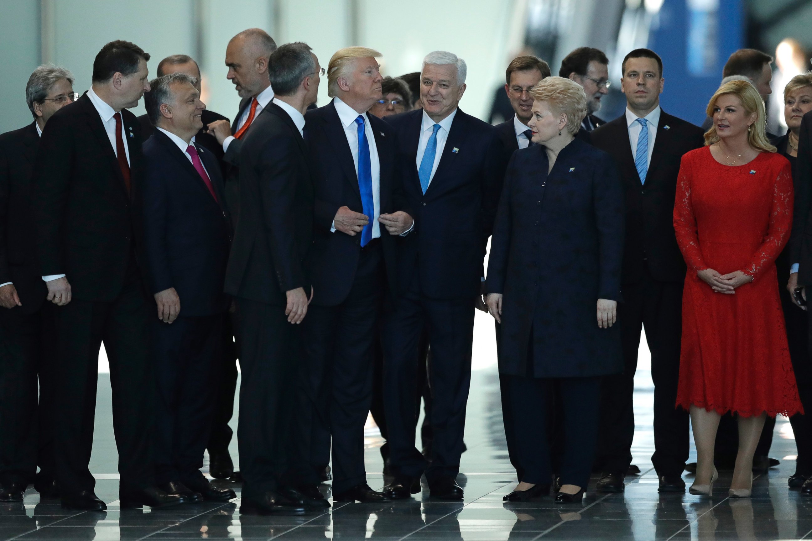 PHOTO: Montenegro Prime Minister Dusko Markovic, center right, smiles after appearing to be pushed by President Donald Trump during a NATO summit of heads of state and government in Brussels on May 25, 2017.