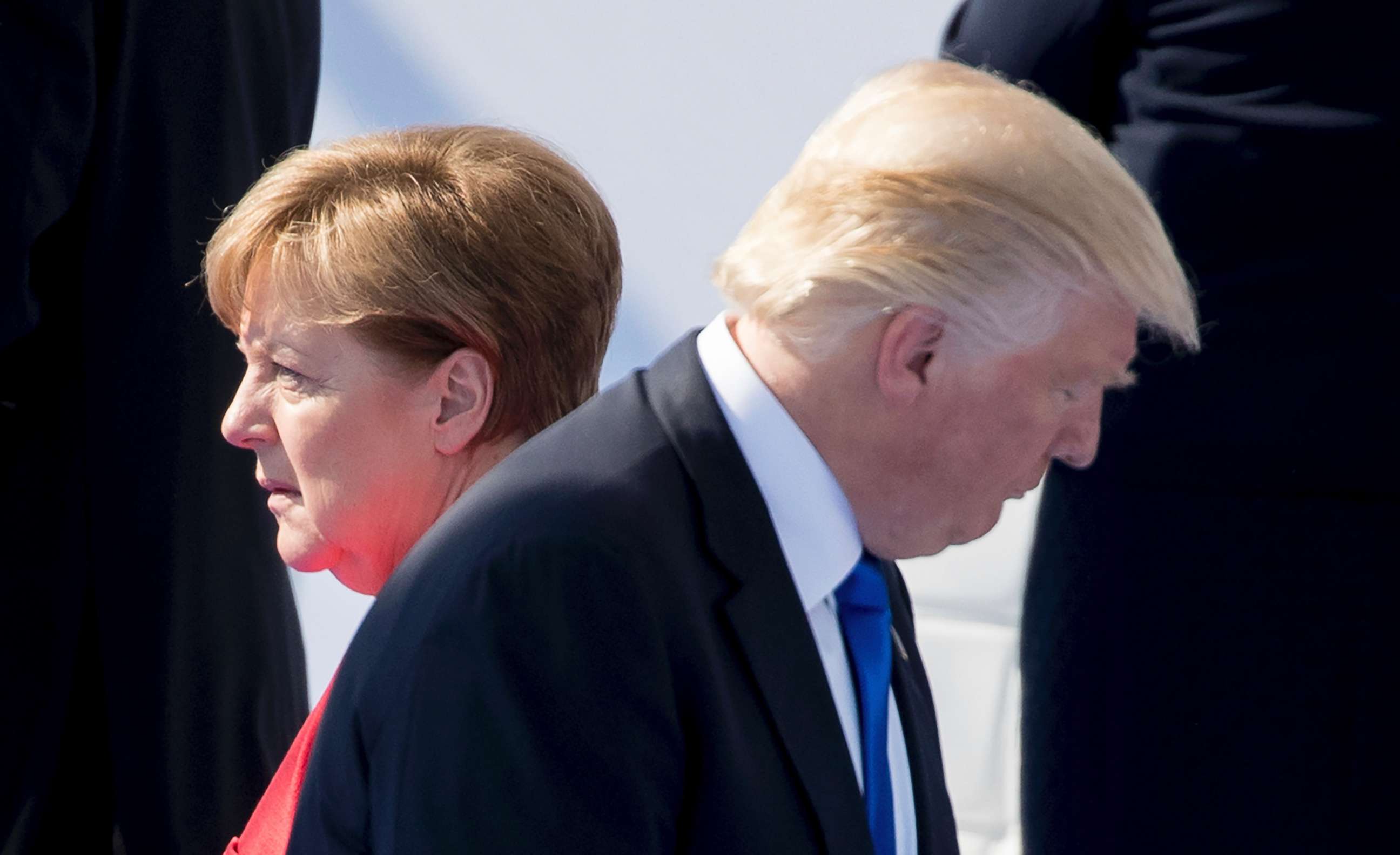 PHOTO: President Donald Trump and German chancellor Angela Merkel walk by each other during the NATO summit for the formal inauguration of the NATO headquarters in Brussels, May 25, 2017.