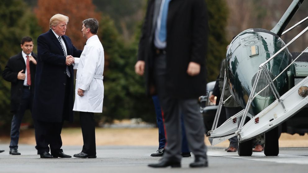 President Donald Trump shakes hands with White House physician Dr. Ronny Jackson as he boards Marine One to leave Walter Reed National Military Medical Center in Bethesda, Md., Friday, Jan. 12, 2018.