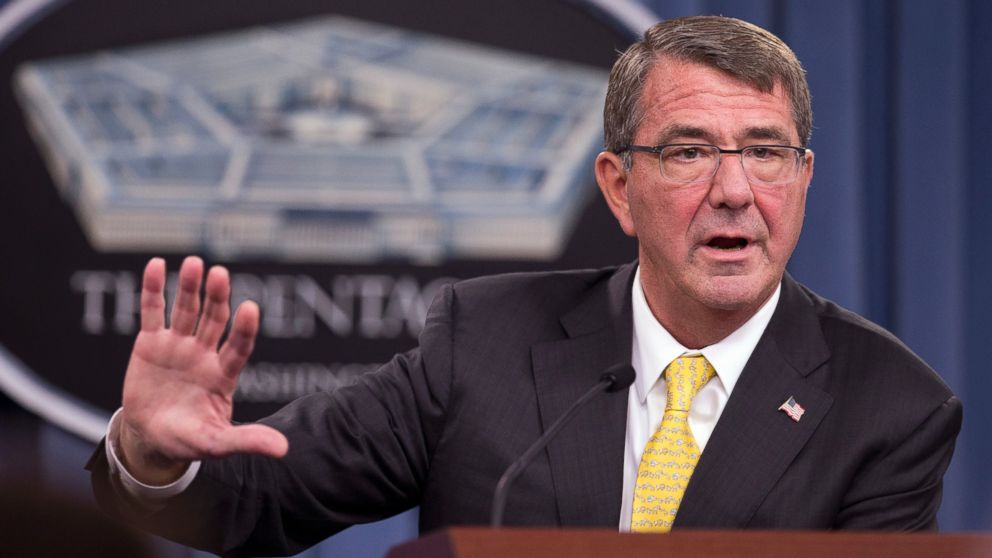 Secretary of Defense Ash Carter steadies his hand using the