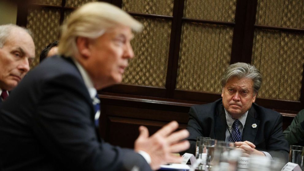 White House Chief Strategist Steve Bannon listens at right as President Donald Trump speaks during a meeting on cyber security in the Roosevelt Room of the White House in Washington,  Jan. 31, 2017. 