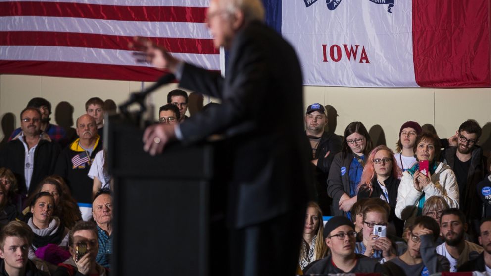 People look on as Democratic presidential candidate Sen. Bernie Sanders speaks during a campaign rally at Grand River Event Center, Jan. 29, 2016, in Dubuque, Iowa.