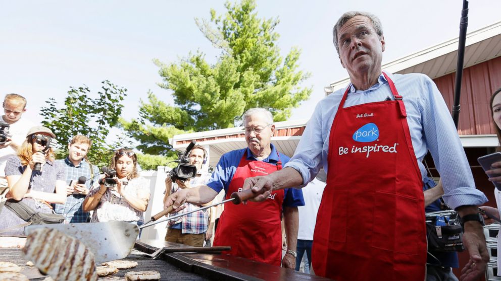 Republican presidential candidate, former Florida Gov. Jeb Bush, works the grill in the Iowa Pork Producers tent during a visit to the Iowa State Fair, Aug. 14, 2015, in Des Moines, Iowa. 