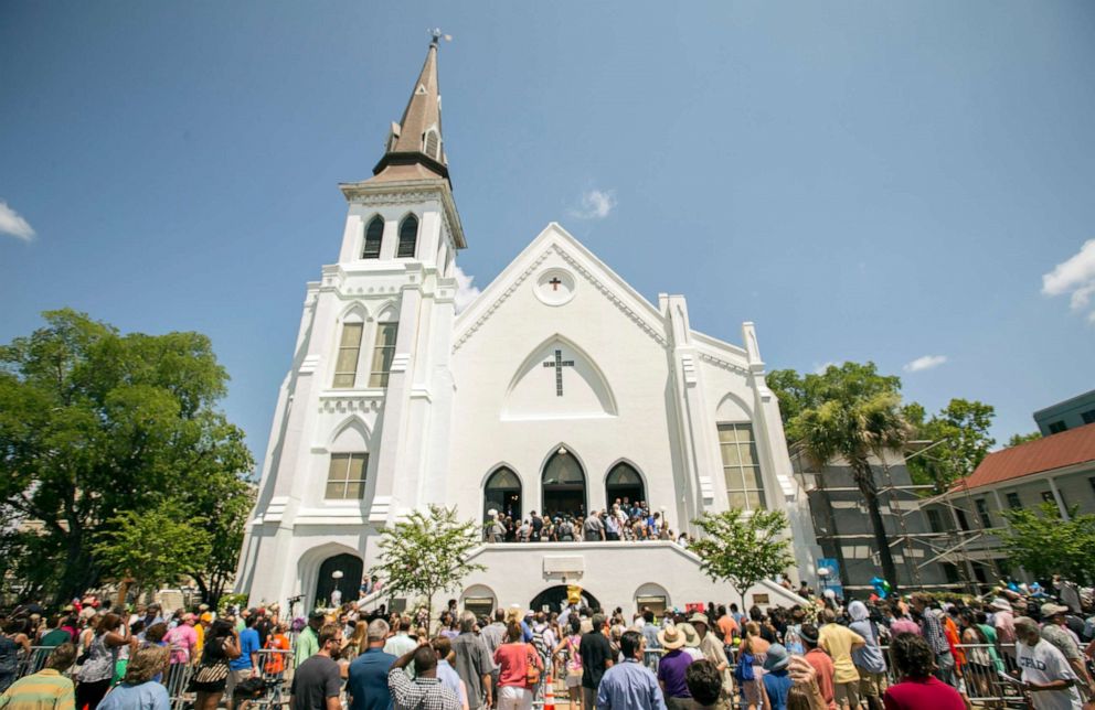 PHOTO: People stand outside as parishioners leave the Emanuel A.M.E. Church, Sunday, June 21, 2015, in Charleston, S.C.