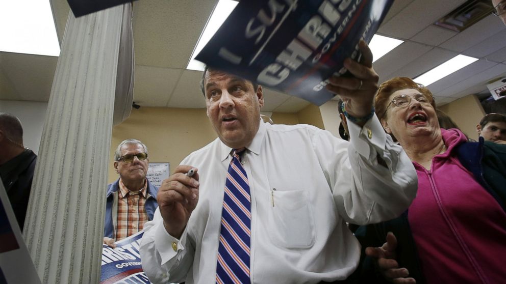 New Jersey Gov. Chris Christie autographs signs in Linden, N.J., Oct. 30, 2013, during a campaign stop.